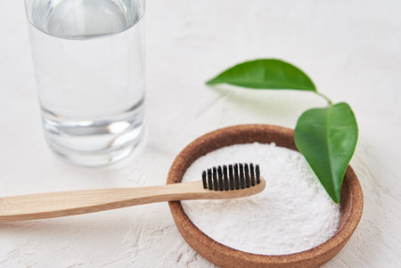 Bamboo toothbrush, baking soda and glass of water on a white background. Eco friendly toothbrushes, zero waste conceptの写真素材