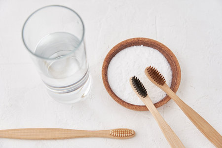 Bamboo toothbrushes, baking soda and glass of water on a white background. Eco friendly toothbrushes, zero waste conceptの写真素材