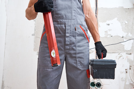 Builder man in uniform with a construction tools. Repair concept