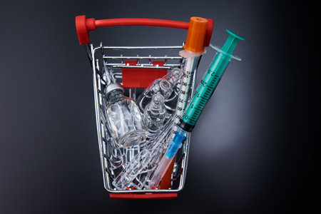 Syringes and ampoules with medicine in a shopping cart. Purchase of medicines coceptの写真素材