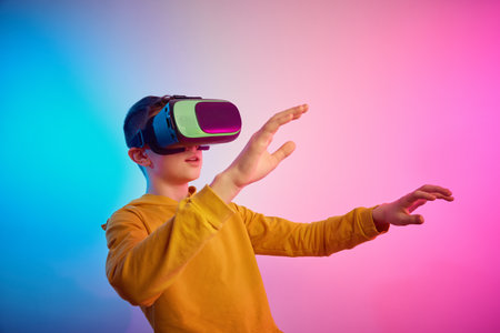 Boy with virtual reality glasses on the colorful background. Future technology, VR concept