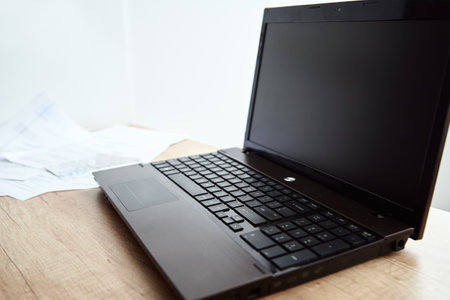 Freelancer home workplace. Laptop on table in the office interior. Online job and remote work.