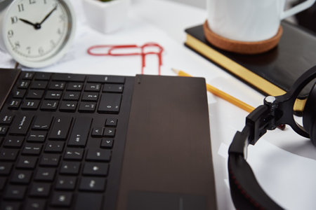 Freelancer home workplace. Laptop on table in the office interior. Online job and remote work.