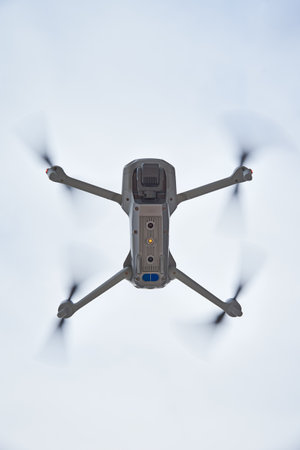 Drone quadcopter with camera flying in the sky