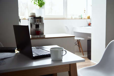Freelancer home workplace. Laptop on table in the office interior. Online job and remote work.の写真素材