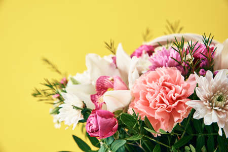 Bunch of fresh summer flowers on yellow backgroundの写真素材