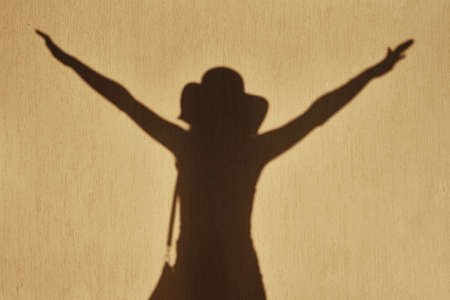 Happy woman shadow on wall. Positive motions conceptの写真素材