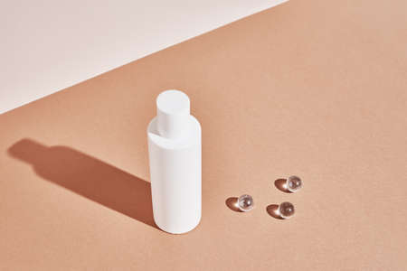 Beaty product package. Cosmetic bottle on pastel beige background. Cosmetics mock upの写真素材