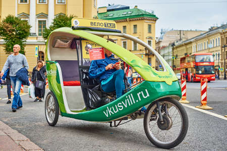 Tourist cycle rickshaw in Saint Petersburg street. SAINT-PETERSBURG, RUSSIA - AUGUST 9, 2019のeditorial素材