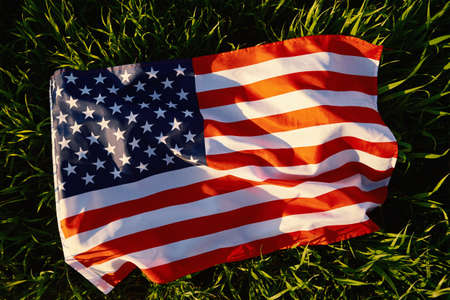 Waving american flag outdoors.USA national flag with grass background. 4th July Independence Dayの写真素材