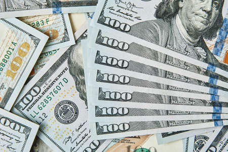 Dollar bills background. Pile of american money cash. One hundred usd dollars banknotes.の写真素材