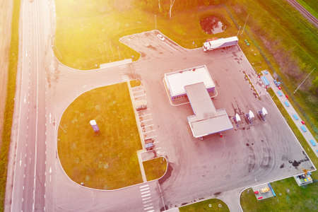 Gas station near highway with moving cars, aerial view.の写真素材