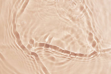 Beige water surface background. Water texture with splashes and bubbles. Summer nature backgroundの写真素材