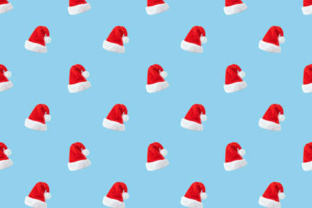 Santa Claus hat seamless pattern on blue background. Christmas backgroundの写真素材