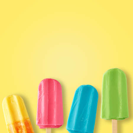Various color ice cream on yellow background with copy space, flat lay top view. Summer conceptの写真素材