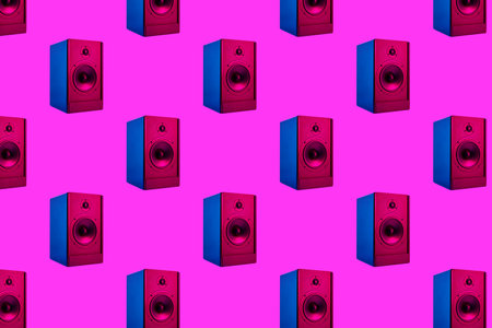 Seamless background with stereo neon colored sound audio speakers on purple backgroundの写真素材
