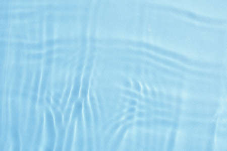 Blue water surface background. Water texture with splashes and bubbles. Summer nature backgroundの写真素材