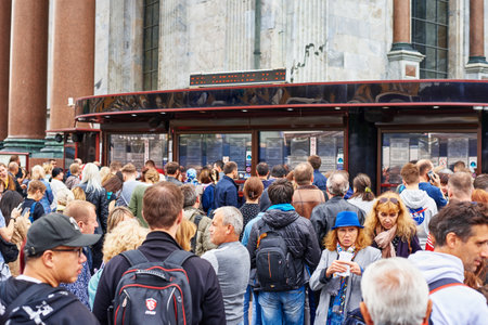 Saint Petersburg, Russia - August 9, 2019: Big crowd of people. Tourists queue at the ticket office...