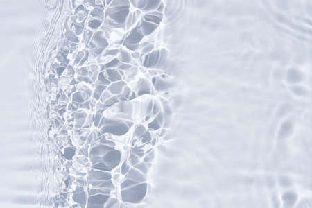 White water surface background. Water texture with reflections, splashes and bubbles. Summer nature backgroundの写真素材