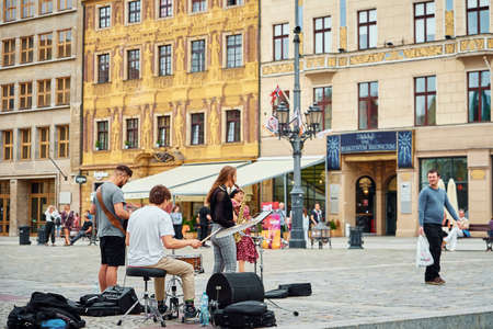Musicians perform on city street in Wroclaw, Poland. Street music. Wroclaw, Poland - July 21, 2021