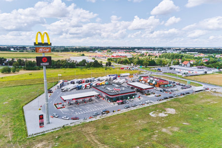McDonalds restaurant on the highway with trucks on parking. Katy Wroclawskie, Poland - August 8, 2021のeditorial素材