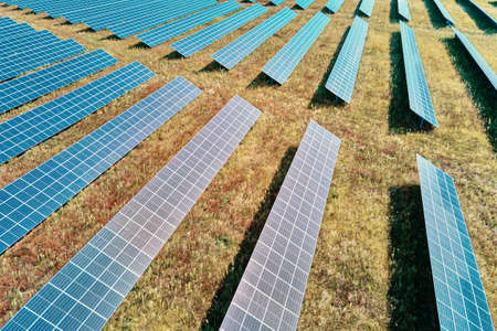 Row of solar panels in the field. Solar battery farm, aerial view. Alternative renewable energy...