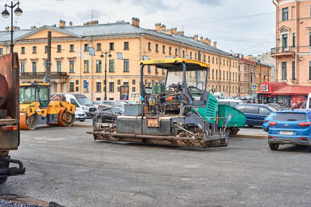 Asphalt paving machine in city street. Road construction. Saint-Petersburg, Russia - August 8, 2019のeditorial素材