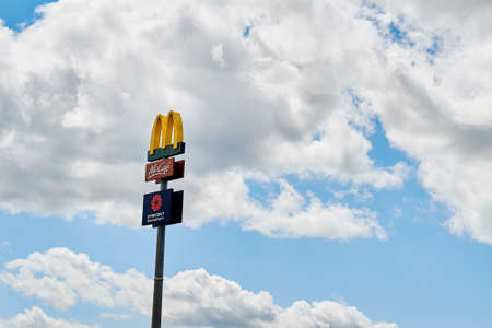 McDonald logo on board against blue sky. McDonalds banner at McDrive cafe. Katy Wroclawskie, Poland - August 10, 2021のeditorial素材