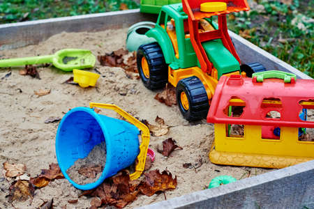 Forgotten toys in the sandbox outside. Children playground outdoorsの写真素材