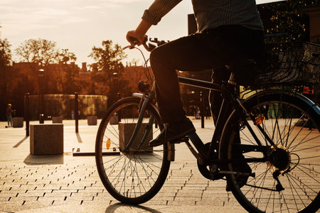 Silhouette of senior man riding on bicycle at city street. Helathy lifestyleの写真素材