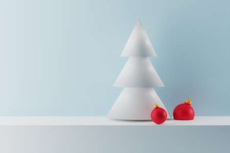 Christmas and New Year background. White christmas tree with red christmas balls on blue background. Winter holiday compositionの写真素材