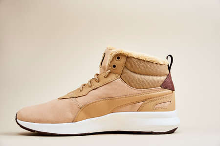 Male boots on beige background. Winter leather stylish shoes
