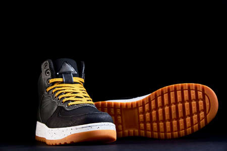 Pair of male shoes on black background, Black stylish boots, close upの写真素材