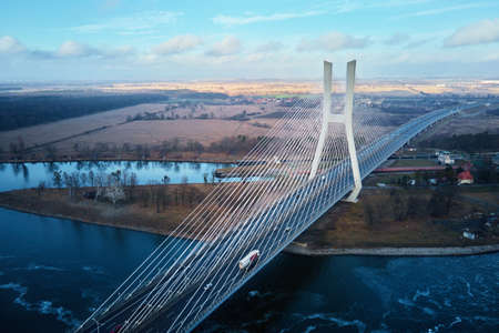 Large modern bridge over river in europe city with car traffic, aerial view. Redzinski bridge over...