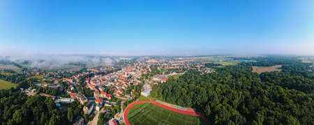 Aerial view of small european town with sradium and sport field, panoramaの写真素材