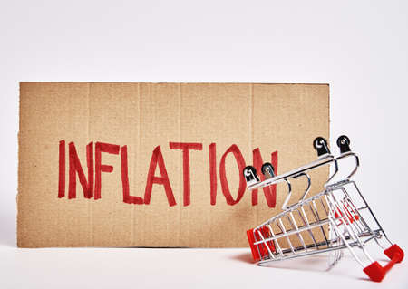 Consumers inflation concept, Rising living costs, Shopping trolley and word inflationの写真素材