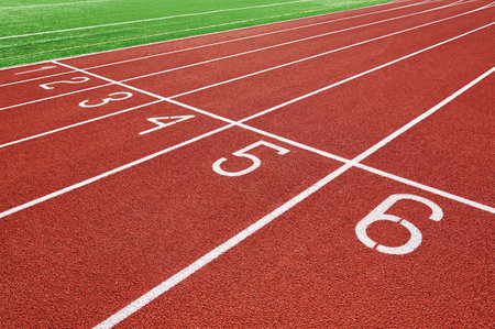 Red runninng race track with lane numbers closeup, Treadmill at stadium, Summer sport and fitness...