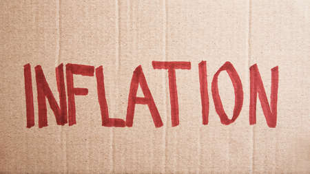 World economic crisis and inflation concept, Paper sheet with word inflation, Rising prices for...