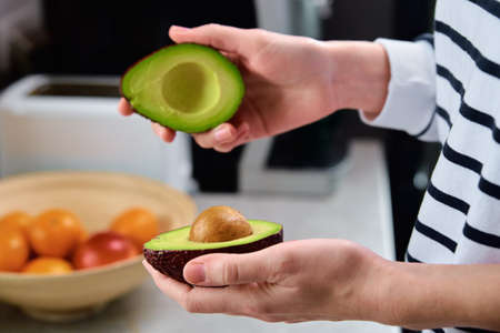 Woman hold fresh ripe avocado, Healthy food and dieting concept, Organic productの写真素材