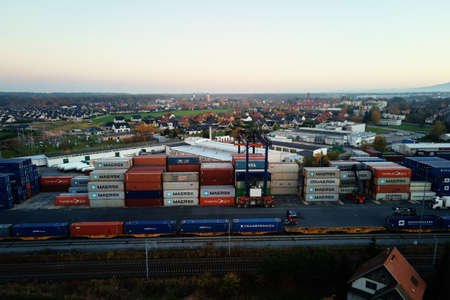 Containers warehouse on platform with cranes and forklifts, aerial view. Business and logistic...