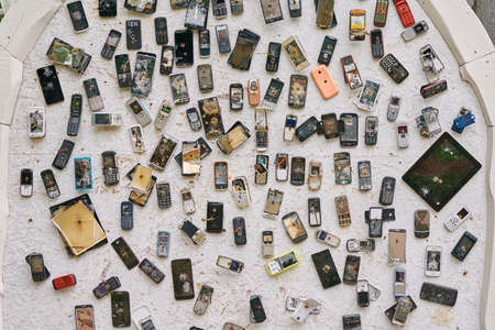 Many old used mobile phones nailed to the wall. Litovka, Belarus - June 13, 2020のeditorial素材