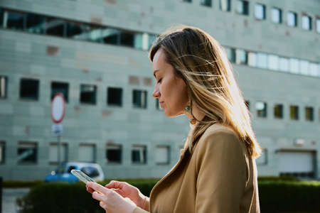 Beautiful Woman Using Smartphone At City Street, Caucasian Female Portrait Using Mobile Phone