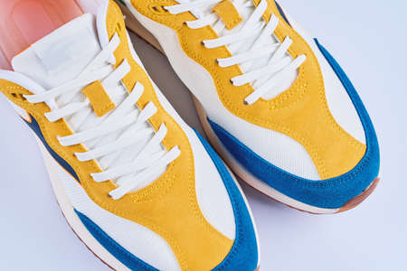 Female sport sneakers on white background, Casual trendy shoes closeup, Creative minimal design with...