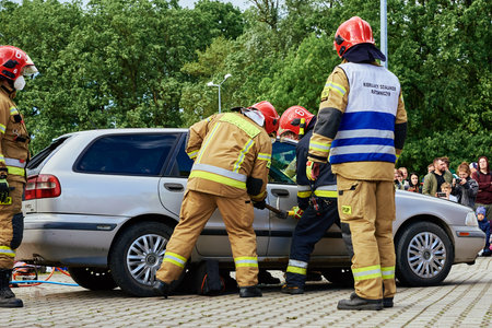 Firefighters use hydraulic tools during a rescue operation training. Rescuers unlock the passenger...