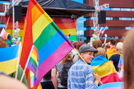 People crowd with LGBTQ rainbow flags on pride parade. Tolerance, diversity and gender identity concept. Wroclaw, Poland - June 11, 2022のeditorial素材