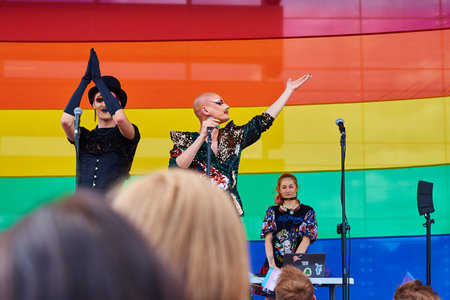 Artist on scene at pride parade with LGBTQ rainbow flags. Tolerance, diversity and gender identity...