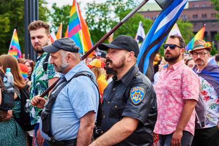 People with LGBTQ rainbow flags on pride parade. Tolerance, diversity and gender identity concept. Crowd on demonstration at city street. Wroclaw, Poland - June 11, 2022のeditorial素材