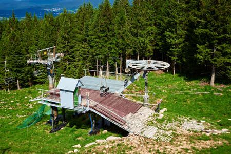 Beautiful mountains, covered with forest and open cable car line. Karpacz resort in Poland with lift road. Family outdoor recreation in mountainsの写真素材
