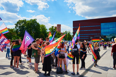 People with LGBTQ rainbow flags on pride parade. Tolerance, diversity and gender identity concept....
