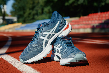 Asics Gel Nimbus running shoes at stadium track, Pair of Asics sport sneakers for jogging. Katy Wroclawskie, Poland - August 07, 2022のeditorial素材